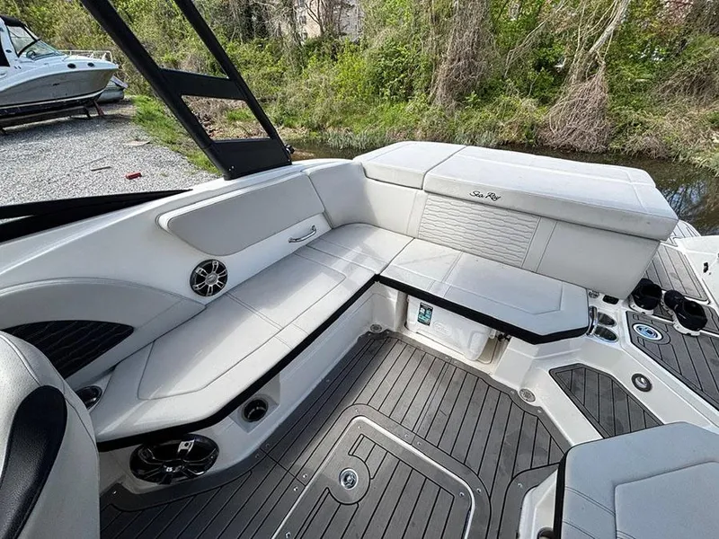 Slide: The Image of 2022 Sea Ray SPX 230 boat interior with white seating and sleek design. - 9