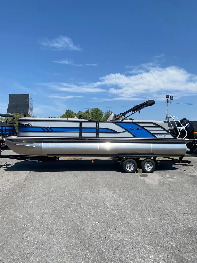 Slide: The Image of 2025 Bentley Pontoons Elite 253 Admiral on trailer under clear blue sky. - 12