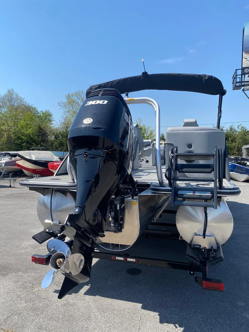 Slide: The Image of 2025 Bentley Pontoons Elite 253 Admiral with powerful outboard motor, docked outdoors. - 15