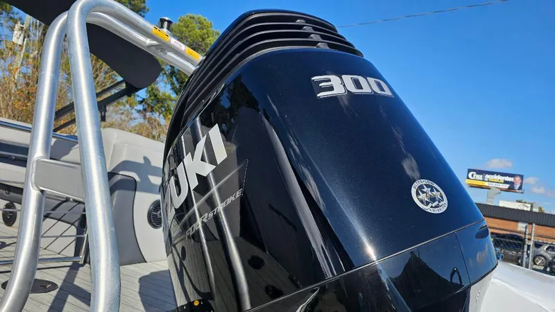 Slide: The Image of 2025 Bentley Pontoons Elite 253 Admiral with Suzuki 300 outboard motor, close-up view. - 2
