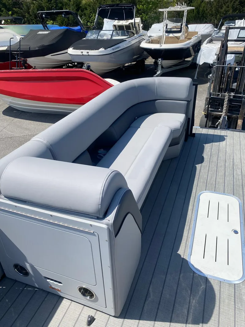 Slide: The Image of 2025 Bentley Pontoons Elite 253 Admiral with luxurious seating on a dock. - 24