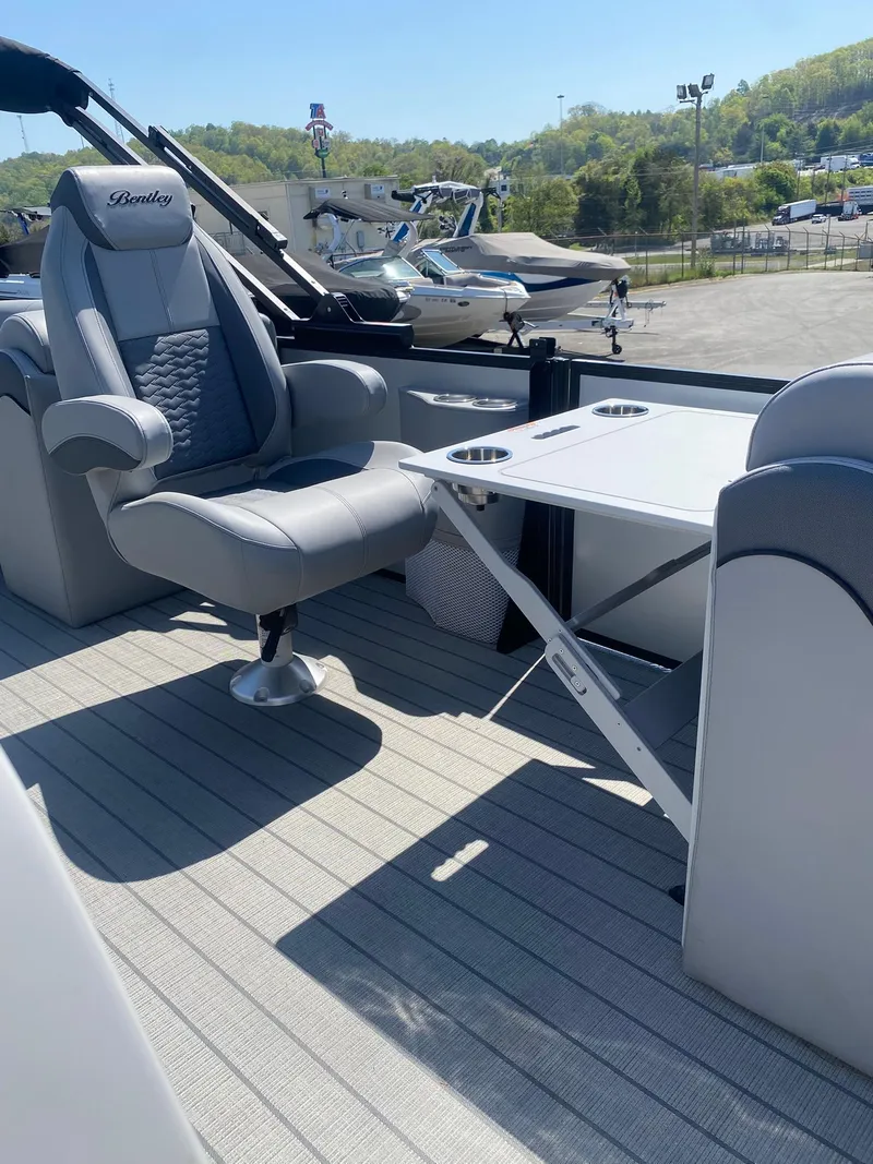 Slide: The Image of 2025 Bentley Pontoons Elite 253 Admiral interior with luxury seating and foldable table. - 33