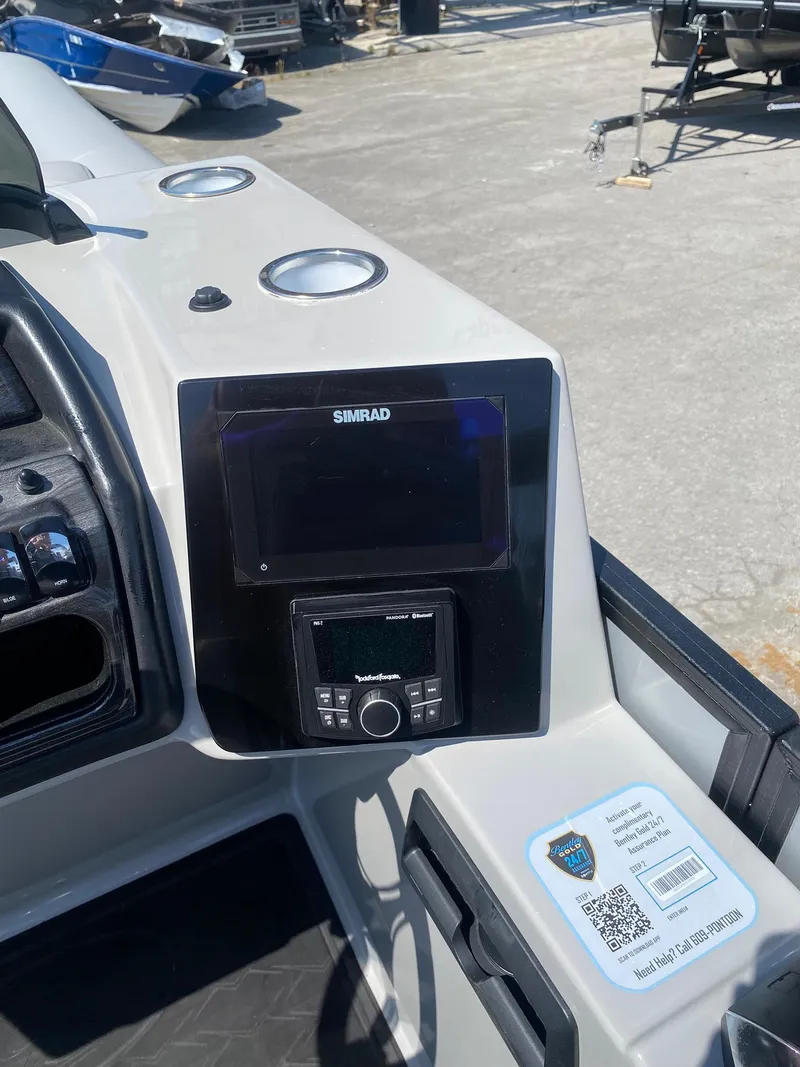 Slide: The Image of 2025 Bentley Pontoons Elite 253 Admiral dashboard with Simrad display and controls. - 36