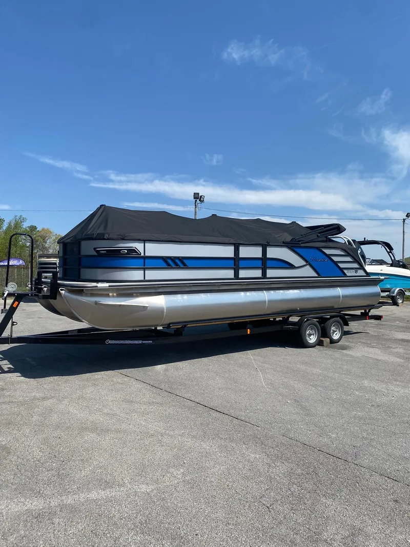 Slide: The Image of 2025 Bentley Pontoons Elite 253 Admiral on trailer, covered, under clear blue sky. - 38
