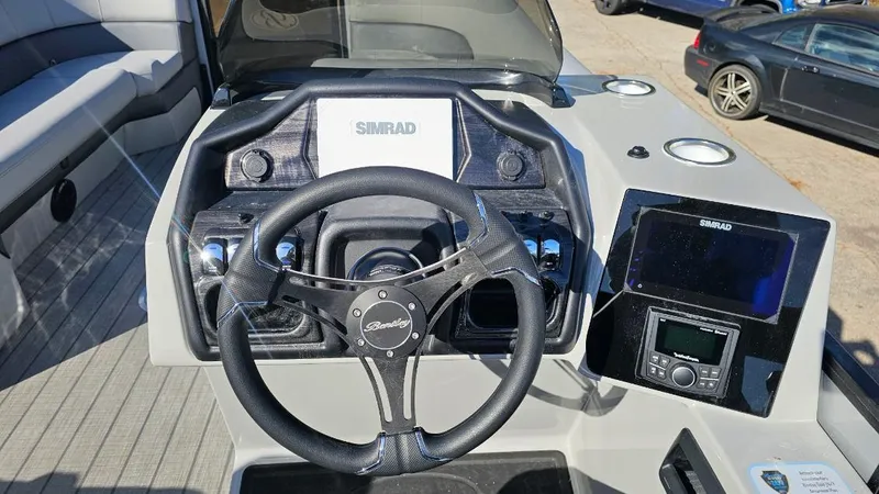 Slide: The Image of 2025 Bentley Pontoons Elite 253 Admiral dashboard with steering wheel and navigation system. - 5