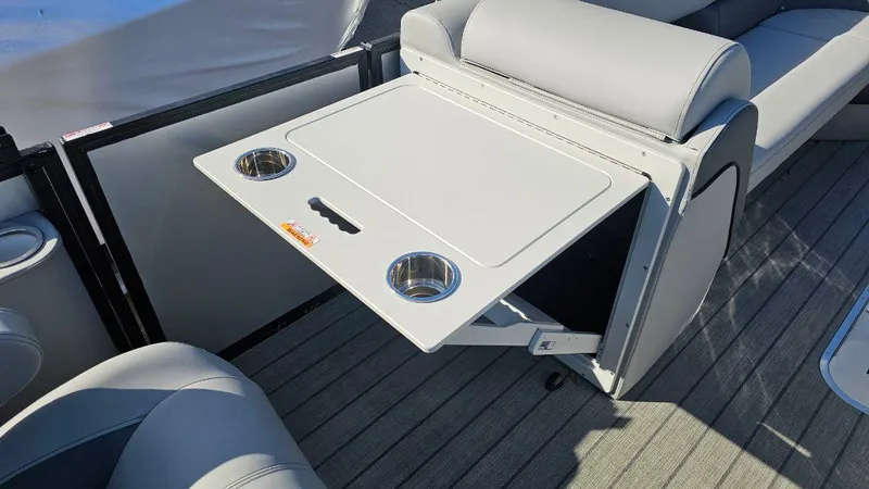 Slide: The Image of 2025 Bentley Pontoons Elite 253 Admiral interior with foldable table and cup holders. - 7