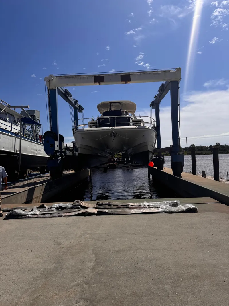 Slide: The Image of Aquila 48 yacht in dry dock, 2018 model, under a clear blue sky. - 10