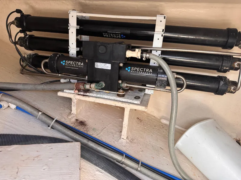 Slide: The Image of Spectra watermaker system in 2018 Aquila 48 yacht, featuring multiple black cylindrical components. - 16