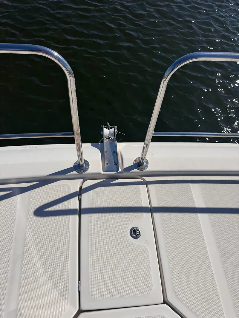 Slide: The Image of Bow of 2018 Aquila 48 yacht with stainless steel railings over water. - 17