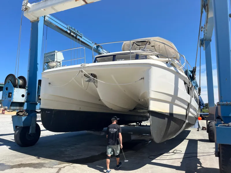 Slide: The Image of Aquila 48 yacht from 2018 being lifted by a boat hoist. - 2