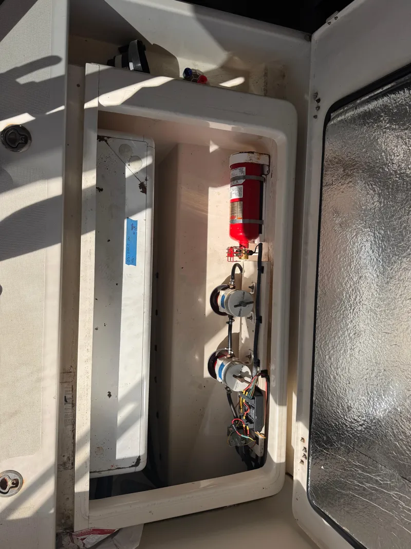 Slide: The Image of Storage compartment in a 2018 Aquila 48 yacht with fire extinguisher and equipment. - 21
