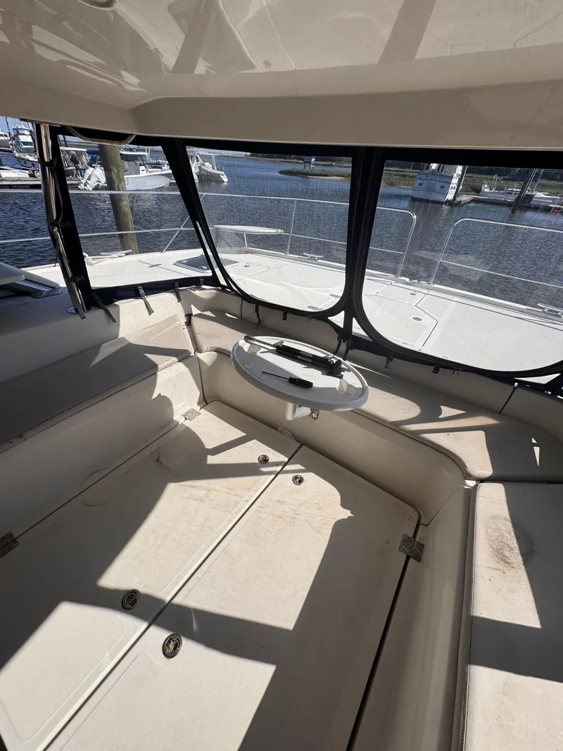 Slide: The Image of Interior view of 2018 Aquila 48 yacht with seating and table, overlooking marina. - 23