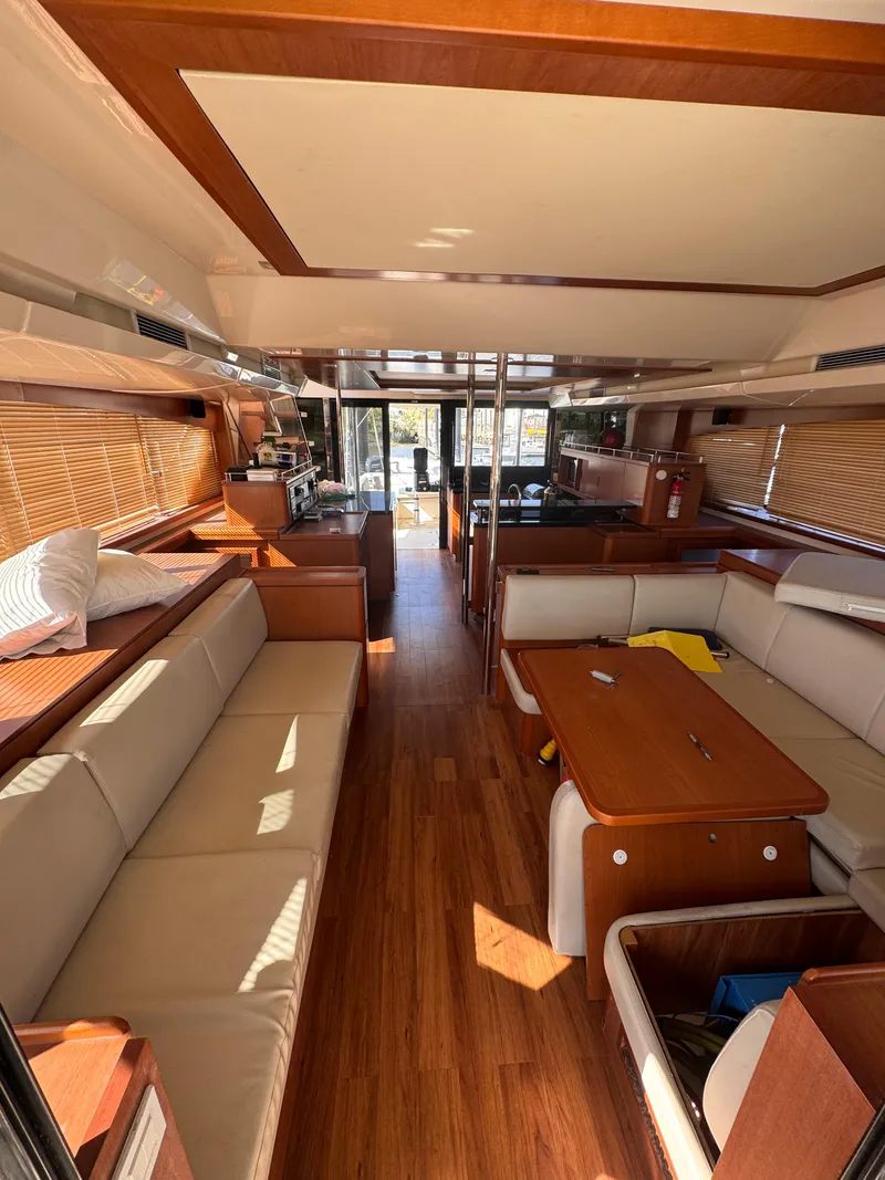 Slide: The Image of Interior of 2018 Aquila 48 yacht with wooden flooring and comfortable seating. - 24