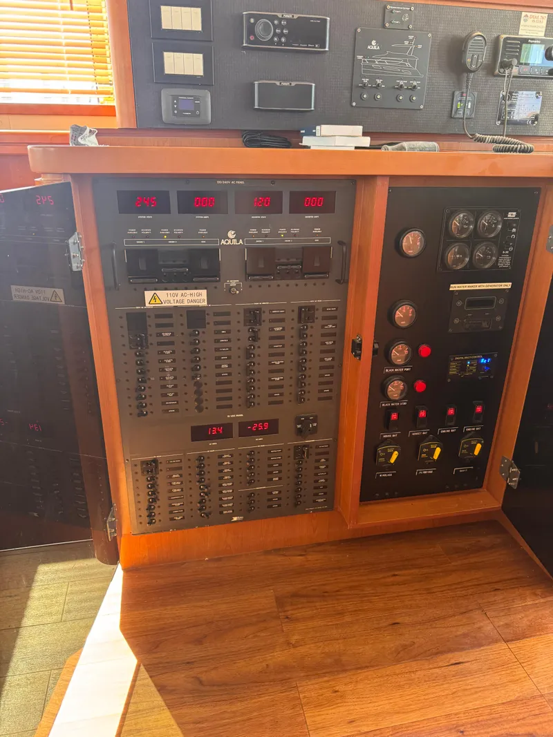 Slide: The Image of Electrical control panel on a 2018 Aquila 48 yacht, featuring switches and gauges. - 28