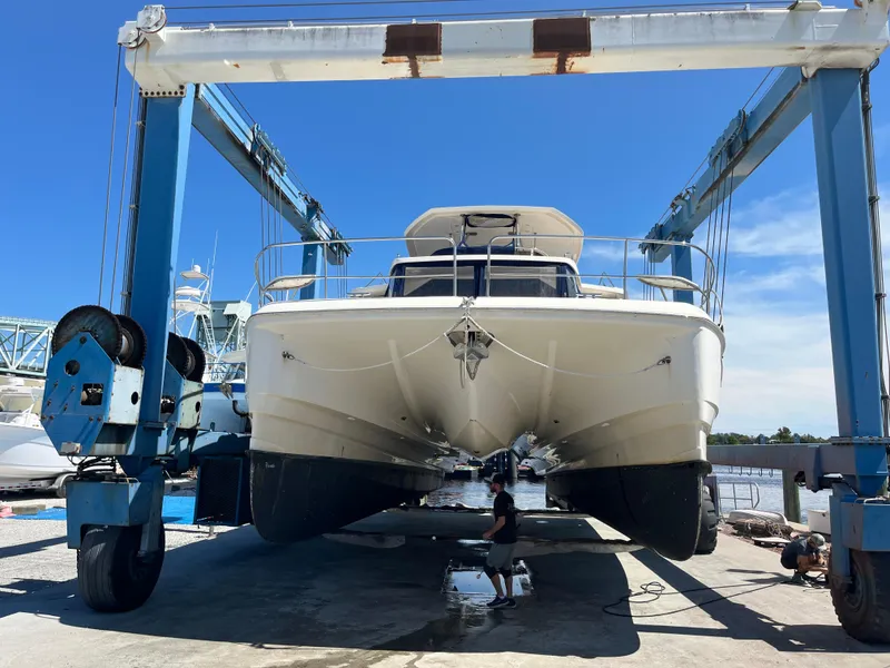 Slide: The Image of Aquila 48 yacht from 2018 in dry dock for maintenance under a clear blue sky. - 3