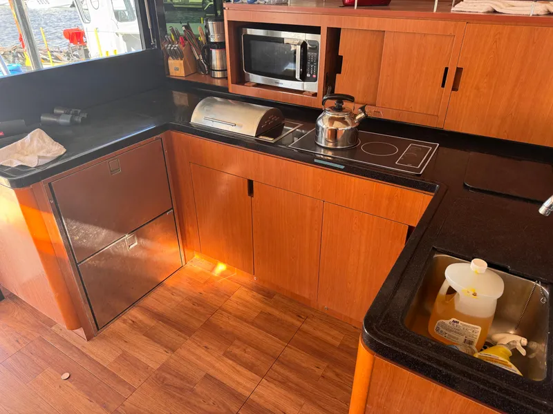 Slide: The Image of Modern kitchen in 2018 Aquila 48 yacht with wooden cabinets and appliances. - 35