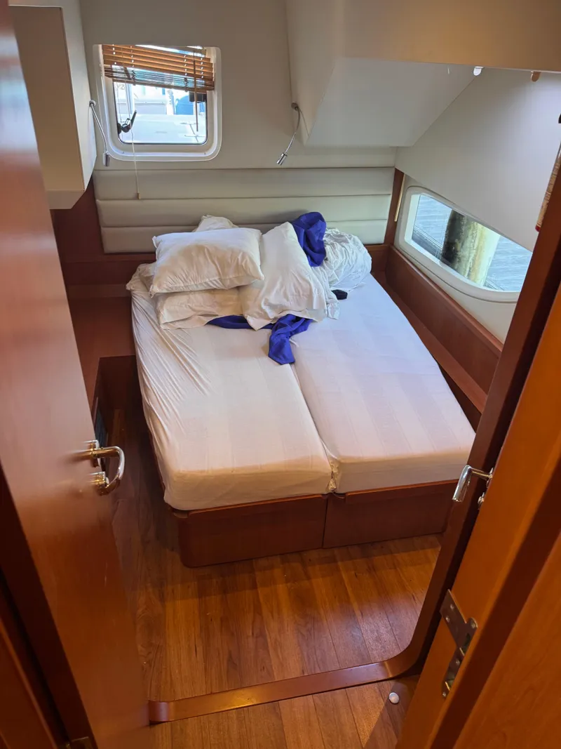 Slide: The Image of Cabin interior of 2018 Aquila 48 yacht with unmade bed and wooden flooring. - 36