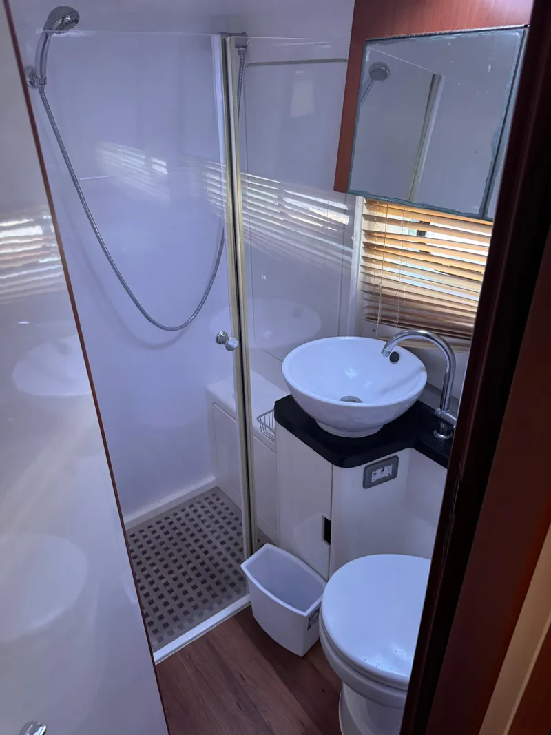 Slide: The Image of Compact bathroom in 2018 Aquila 48 yacht with shower, sink, and toilet. - 38