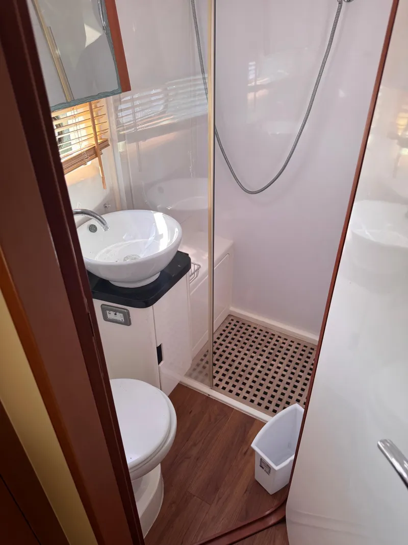 Slide: The Image of Compact bathroom in 2018 Aquila 48 yacht with shower, sink, and toilet. - 41