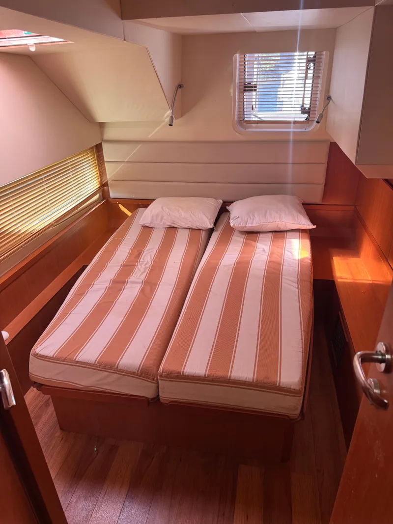 Slide: The Image of Cozy cabin interior of 2018 Aquila 48 yacht with twin beds and wooden accents. - 42