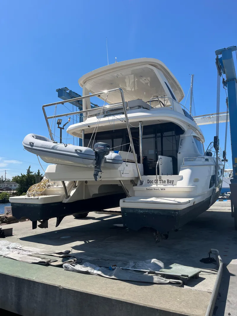 Slide: The Image of Aquila 48 yacht from 2018 on dry dock with inflatable boat attached. - 5