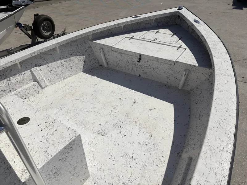 Slide: The Image of Skiff Reno 23 boat interior, 2000 model, with textured flooring and storage compartments. - 13