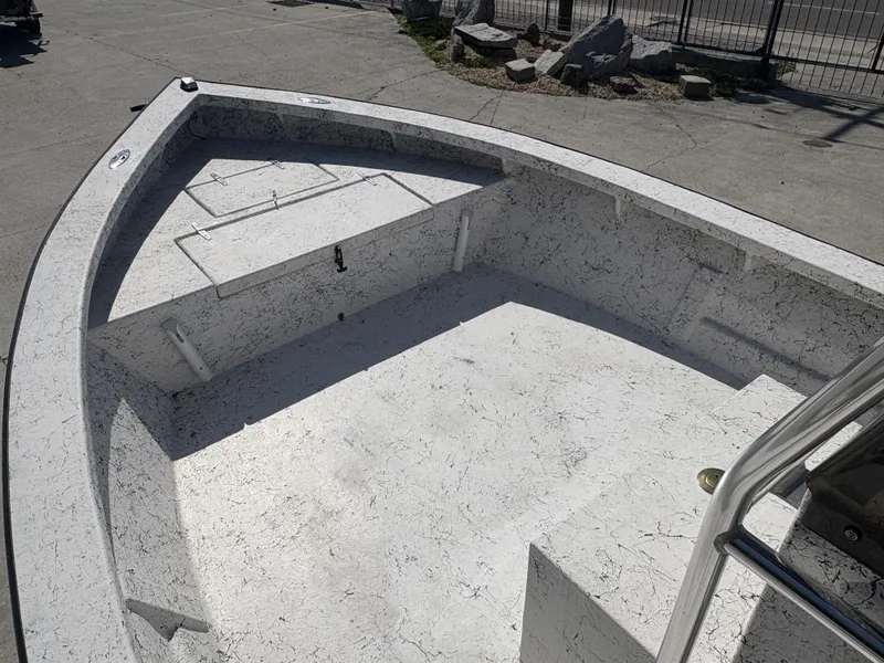 Slide: The Image of Open deck of a 2000 Skiff Reno 23 boat, featuring a clean, textured surface. - 7