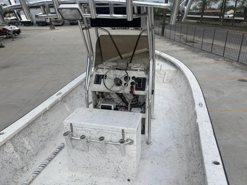 Slide: The Image of Skiff Reno 23 boat, 2000 model, with center console and rod holders, parked outdoors. - 8
