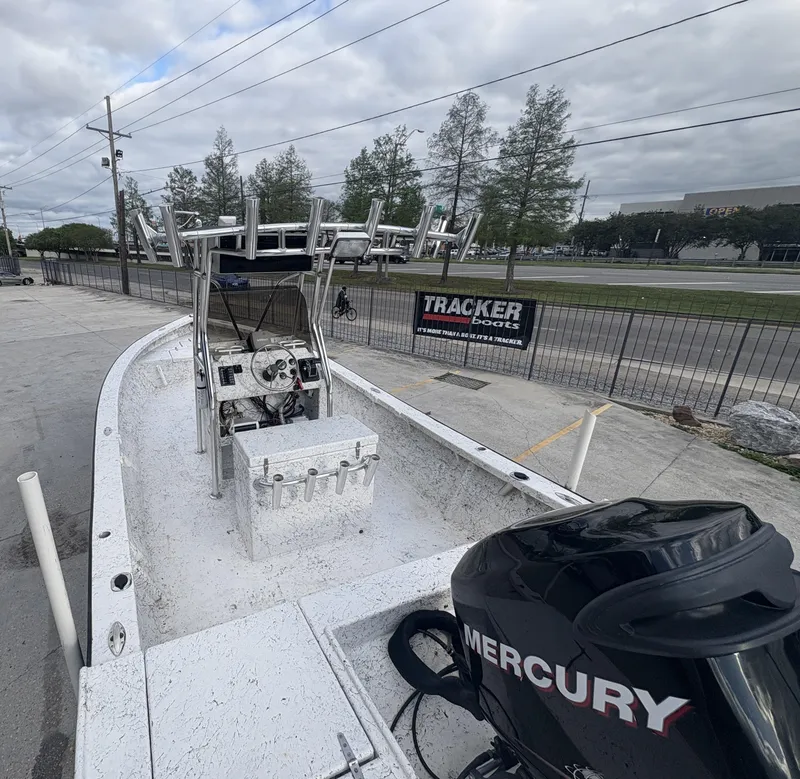 Slide: The Image of Skiff Reno 23 boat, 2000 model, with Mercury engine, parked near Tracker Boats sign. - 9
