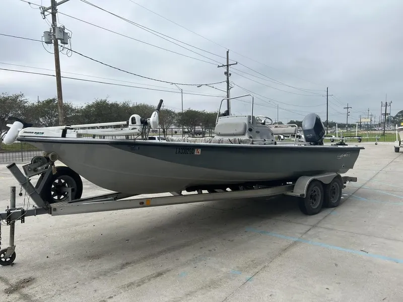 Slide: The Image of 2014 Blue Wave 2200 boat on trailer in parking lot, overcast sky. - 12