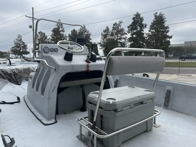 Slide: The Image of 2014 Blue Wave 2200 boat interior with steering console and seating. - 17