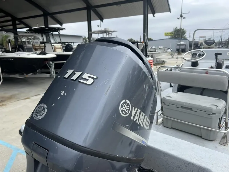 Slide: The Image of 2014 Blue Wave 2200 boat with Yamaha 115 outboard motor in a marina. - 3