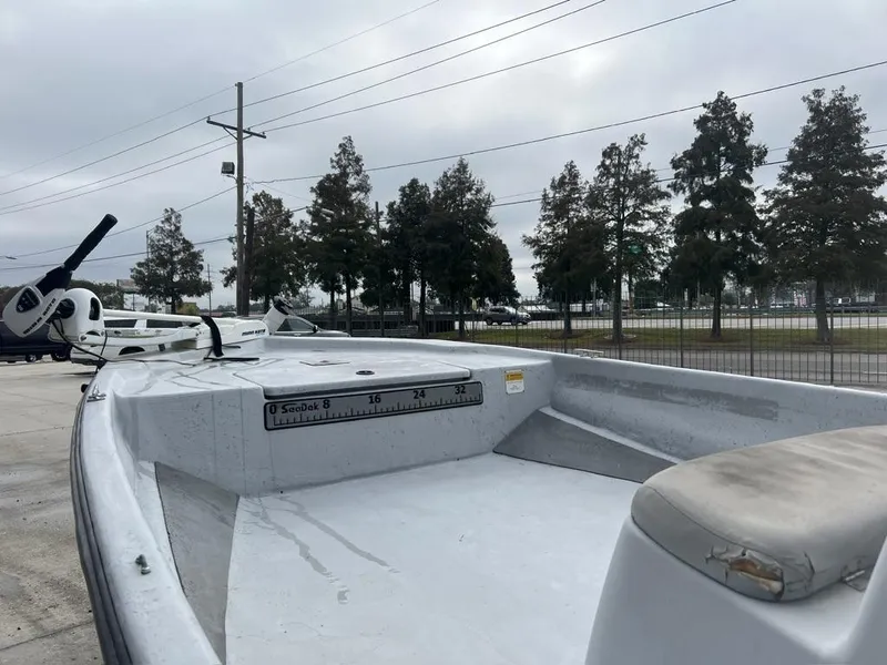 Slide: The Image of 2014 Blue Wave 2200 boat with trolling motor, parked outdoors on a cloudy day. - 5