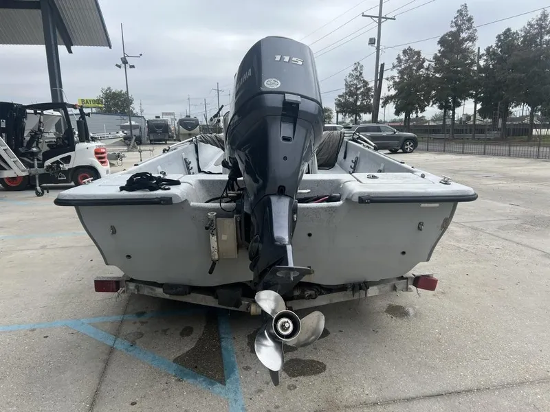 Slide: The Image of 2014 Blue Wave 2200 boat with Yamaha 115 outboard motor, parked in a lot. - 9