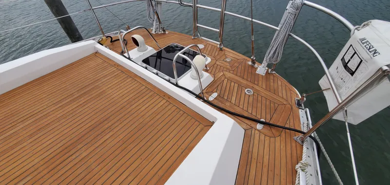 Slide: The Image of Teak deck of 1989 Tayana 55 sailboat with lifebuoy and railing. - 10