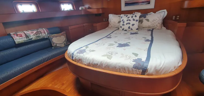 Slide: The Image of Cozy bedroom in 1989 Tayana 55 yacht with elegant wood finish and floral bedding. - 27