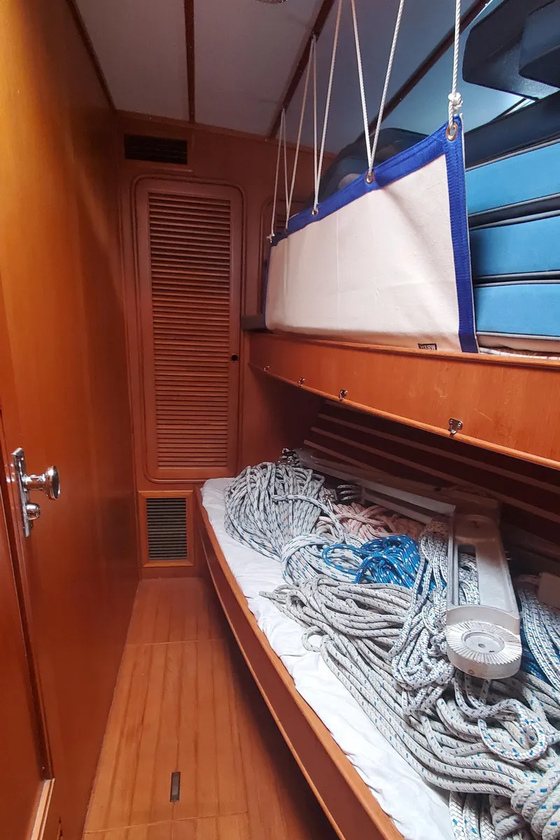 Slide: The Image of Interior of 1989 Tayana 55 sailboat with ropes on a wooden bunk. - 29