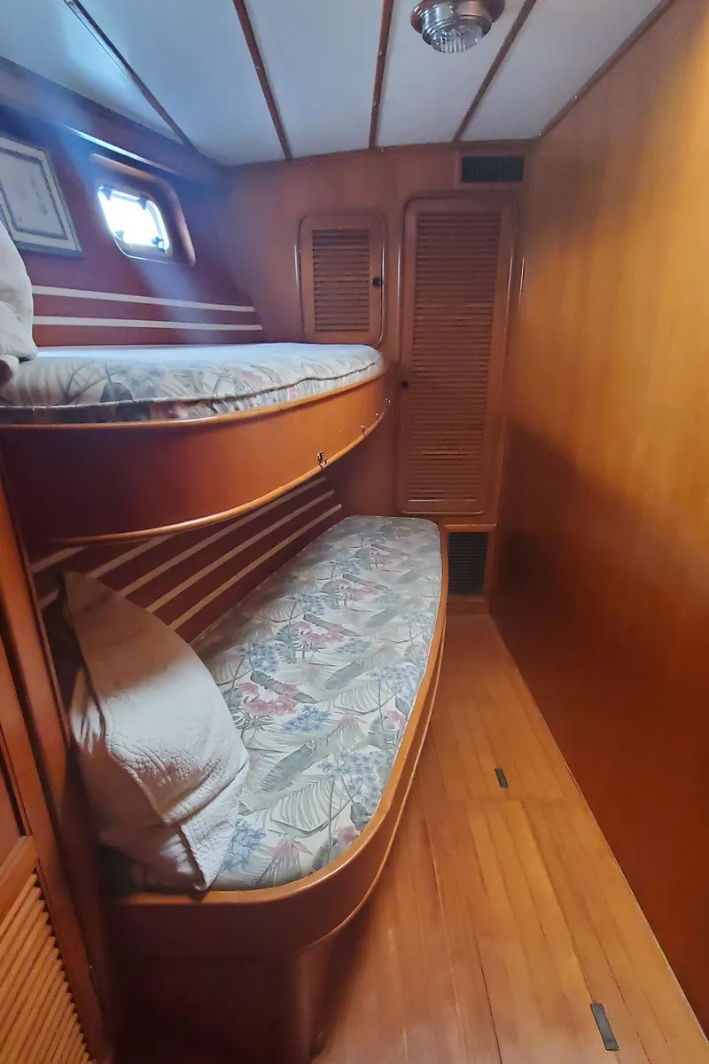 Slide: The Image of 1989 Tayana 55 yacht interior with wooden bunk beds and cozy cabin design. - 30