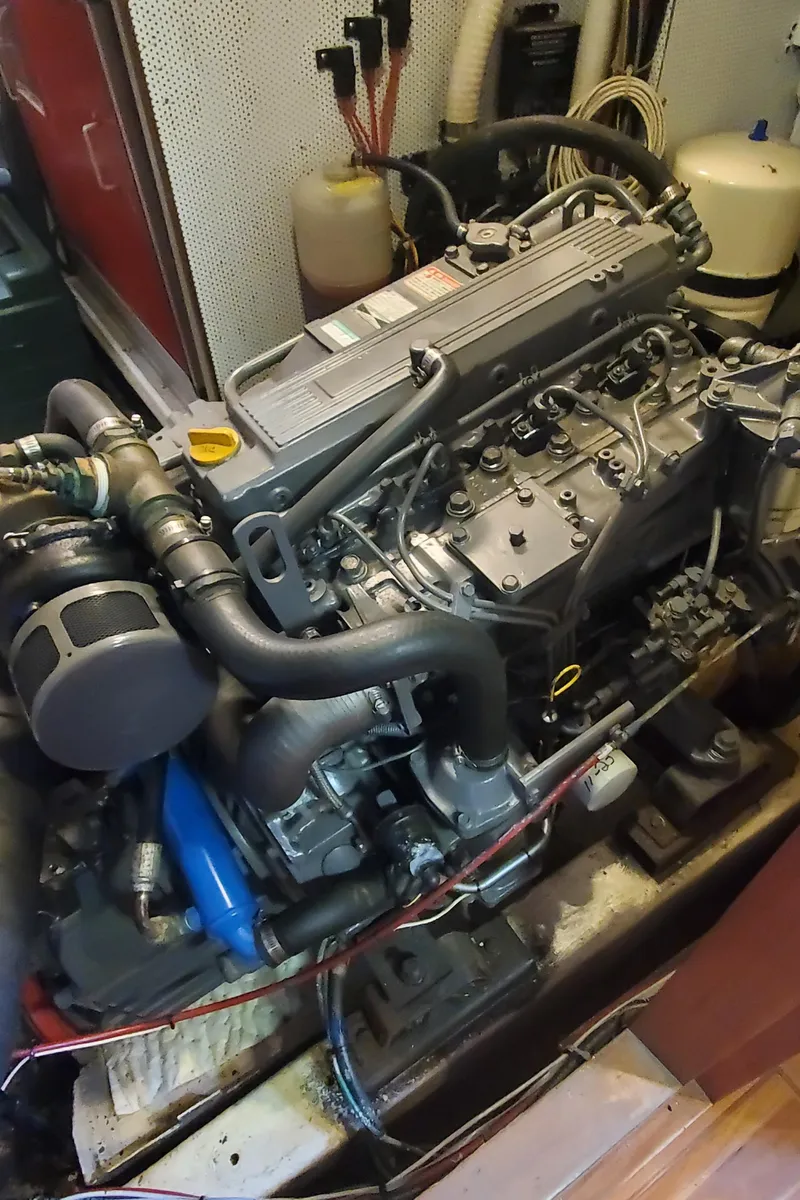 Slide: The Image of Engine of a 1989 Tayana 55 sailboat, showcasing detailed mechanical components. - 32