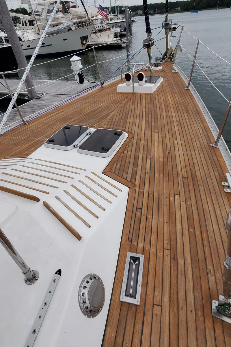 Slide: The Image of Deck of 1989 Tayana 55 yacht with teak wood finish, docked at marina. - 35