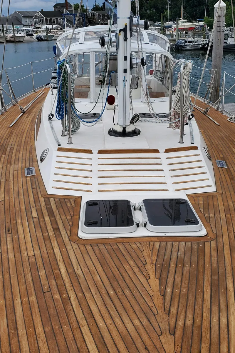 Slide: The Image of 1989 Tayana 55 sailboat with teak deck, docked at marina. - 39