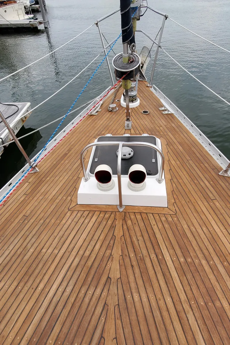 Slide: The Image of Deck of 1989 Tayana 55 sailboat with wooden finish and marine equipment. - 40