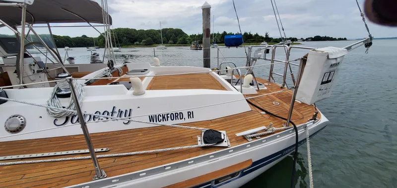Slide: The Image of 1989 Tayana 55 sailboat docked in Wickford, RI, featuring teak deck and elegant design. - 5