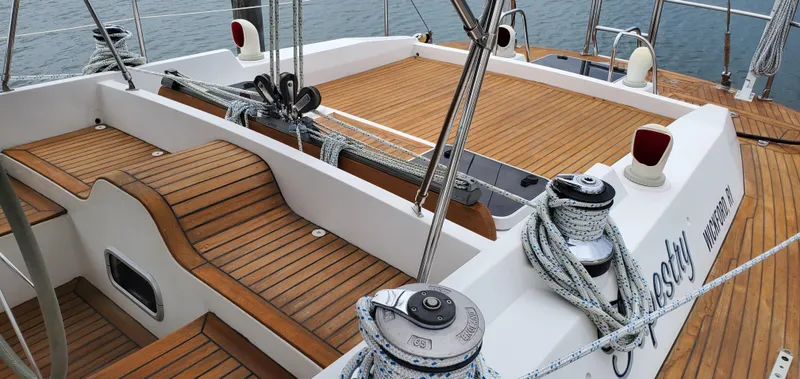 Slide: The Image of Deck of 1989 Tayana 55 sailboat with teak wood finish and rigging details. - 9