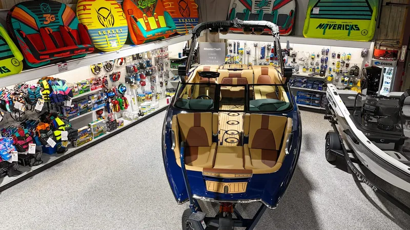 Slide: The Image of 2025 MasterCraft X24 boat displayed in a store with water sports gear. - 6