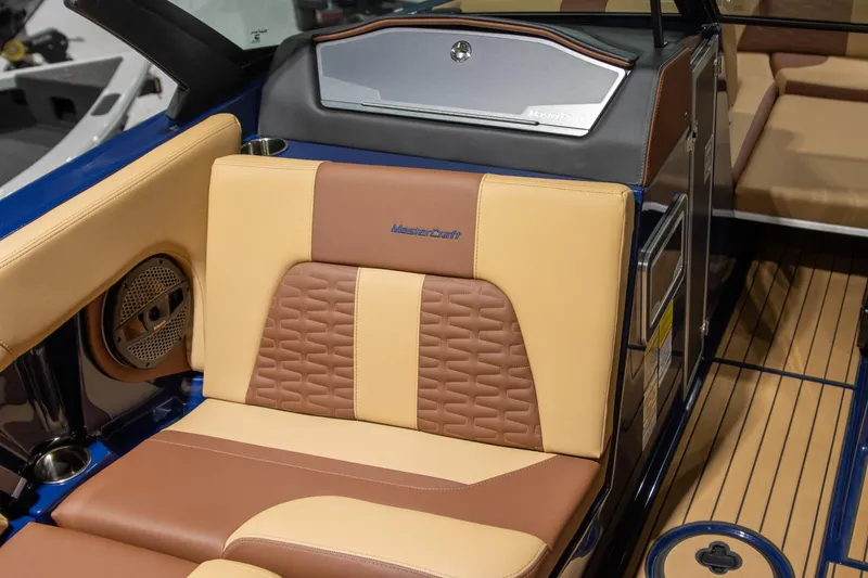 Slide: The Image of 2025 MasterCraft X24 boat interior with tan and brown seating, featuring premium design elements. - 9