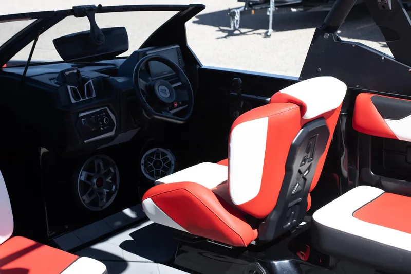 Slide: The Image of 2022 Axis A20 boat interior with red and white seats, steering wheel, and speakers. - 6