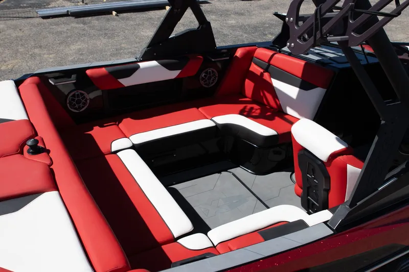 Slide: The Image of 2022 Axis A20 boat interior with red and white seating, featuring speakers and modern design. - 9