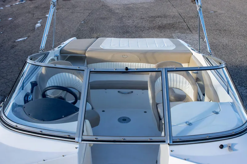 Slide: The Image of 2016 Stingray 215LR Sport Deck boat interior with seating and steering wheel. - 7