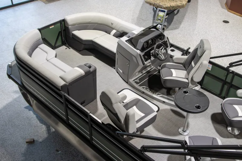Slide: The Image of 2024 Viaggio Lago Z 22Q pontoon boat interior with modern seating and steering console. - 9